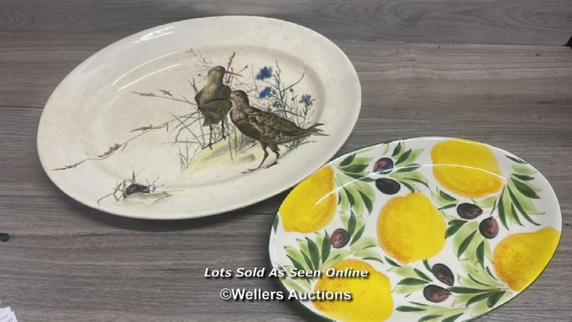 LARGE DEPOSE OVAL PLATTER DECORATED WITH BIRDS AND A SMALLER PLATTER DECORATED WITH LEMONS,