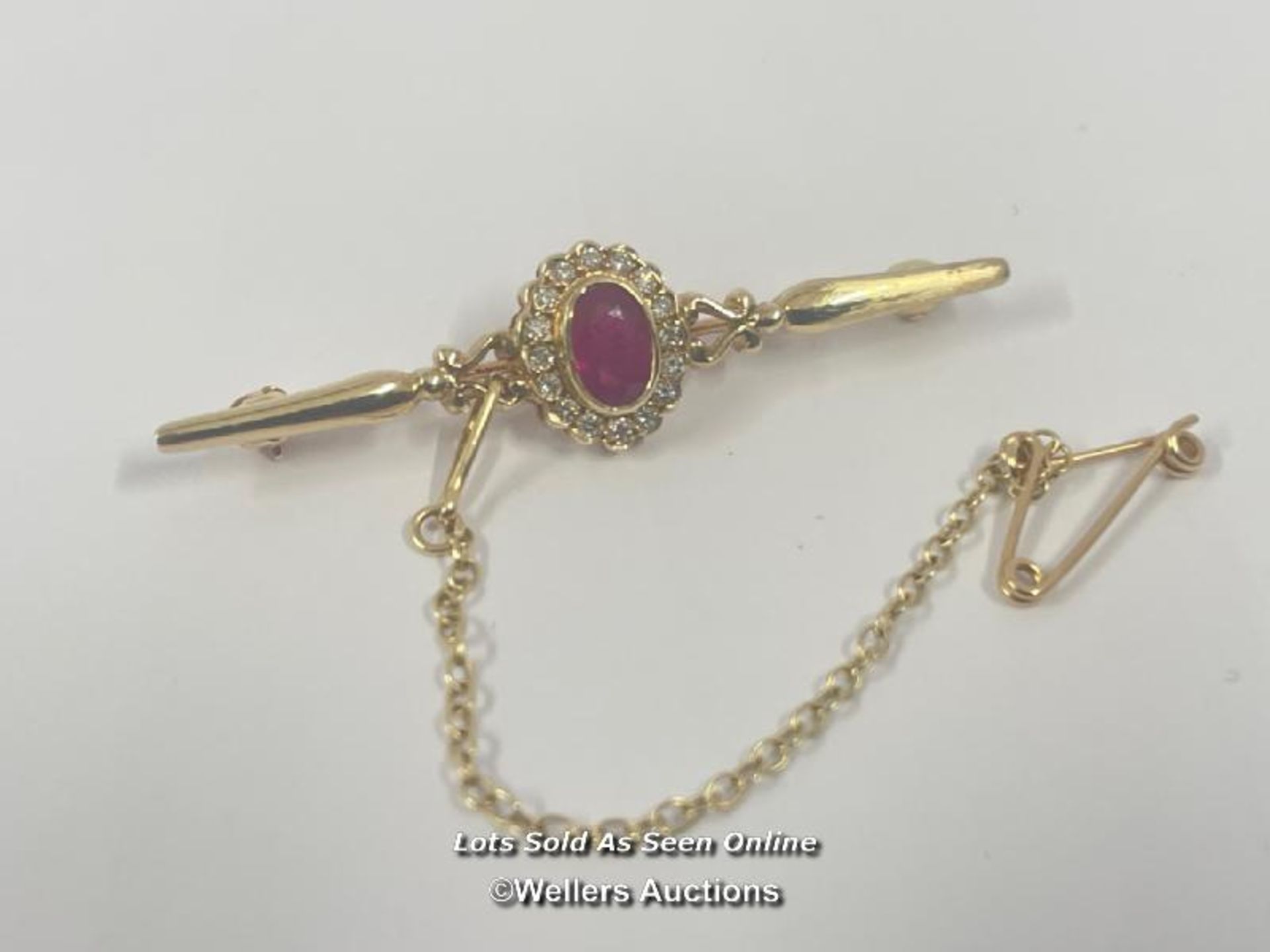 RUBY AND DIAMOND BAR BROOCH WITH SAFETY CHAIN, RUBY ESTIMATED WEIGHT 0.54CT, DIAMONDS ESTIMATED