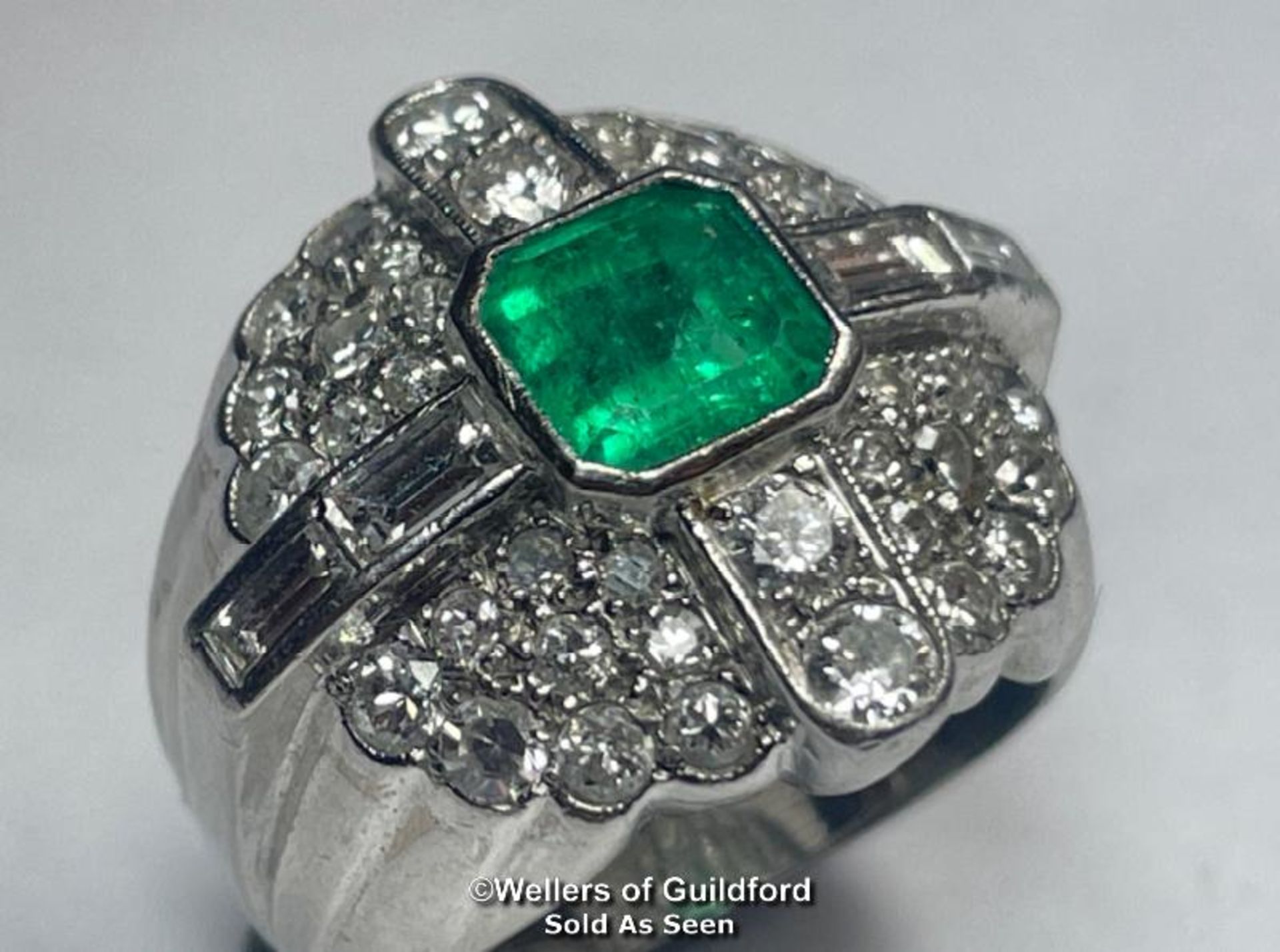 EMERALD AND DIAMOND RING STAMPED PT950, SET WITH ROUND BRILLIANT CUT, SINGLE CUT AND BAQUETTE CUT