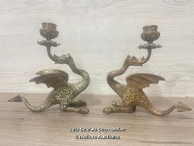 A PAIR OF BRASS CANDLE HOLDERS FORMED AS DRAGONS, 18CM HIGH