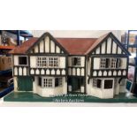 *A large wooden dolls house in need of restoration, 120 x 61 x 43cm