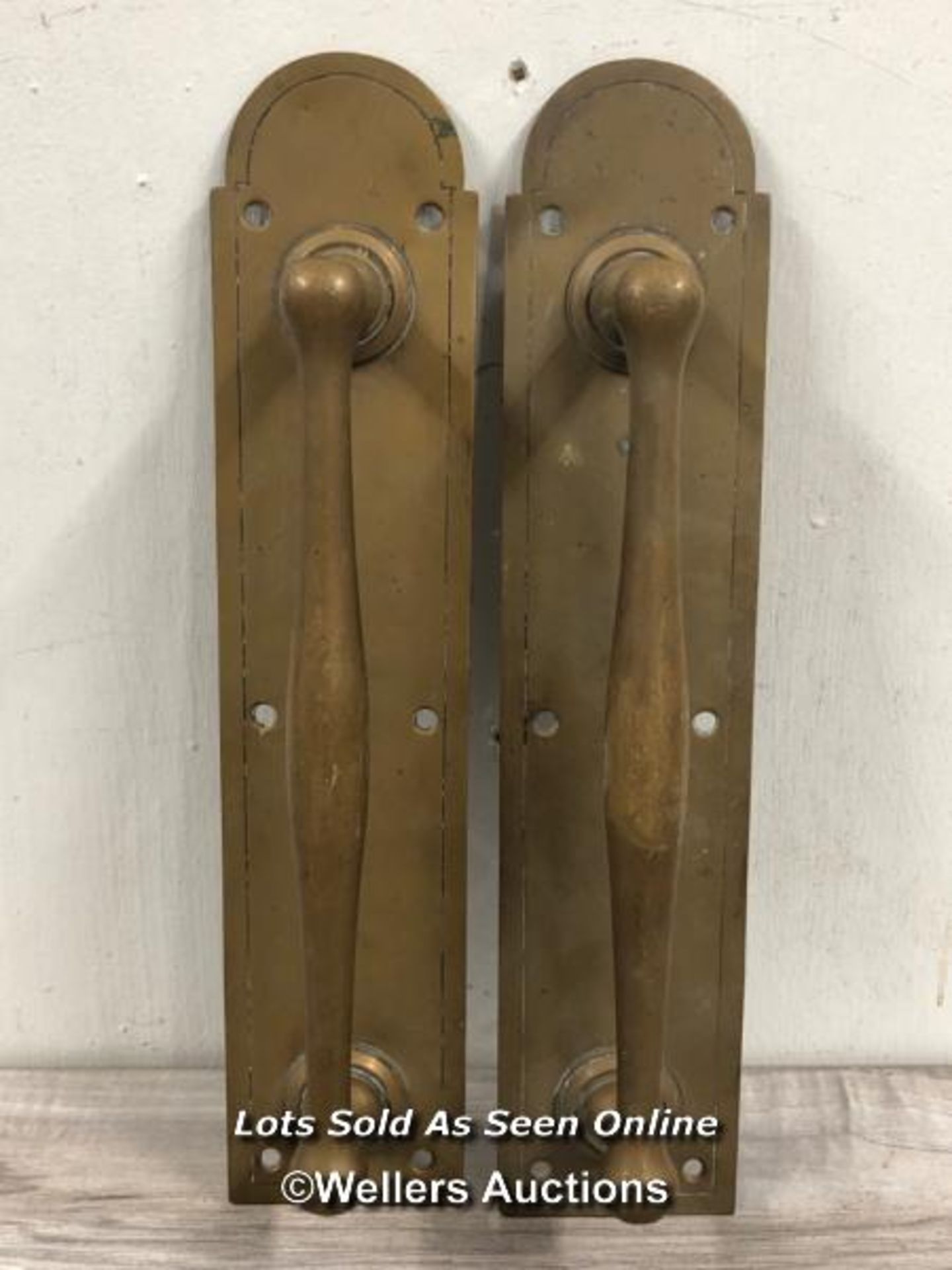 *MATCHING PAIR OF BRASS PULL HANDLES, MOUNTED AGAINST BACK PLATE WITH BOW-TOP DESIGN, 36CM (L) X 7.