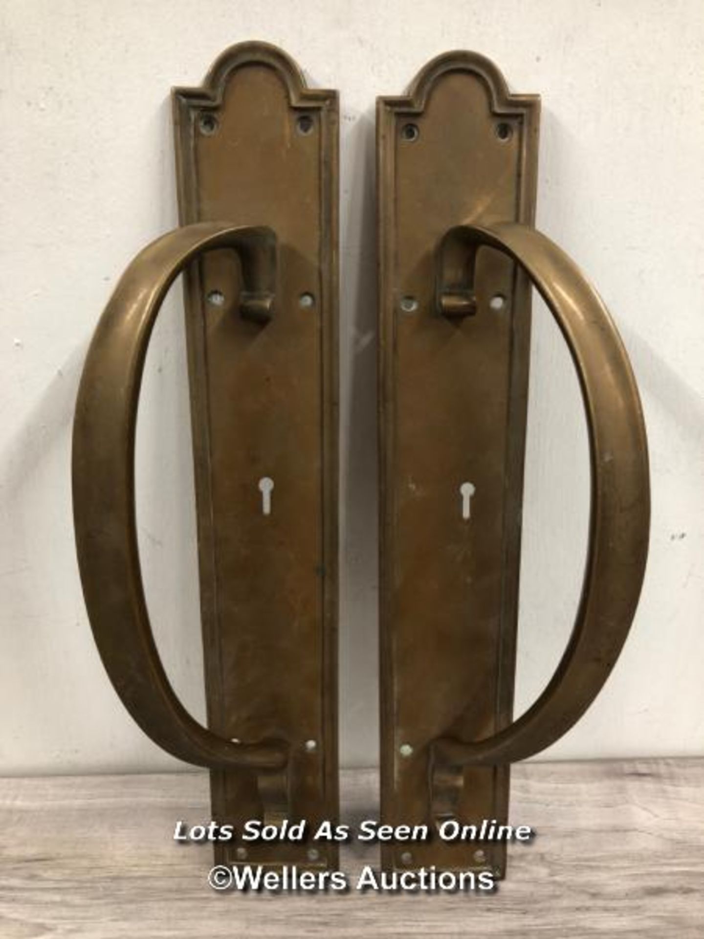 *MATCHING PAIR OF BRASS PULL HANDLES WITH KEY HOLE INSERTS, MOUNTED AGAINST BACK PLATE WITH RAISED