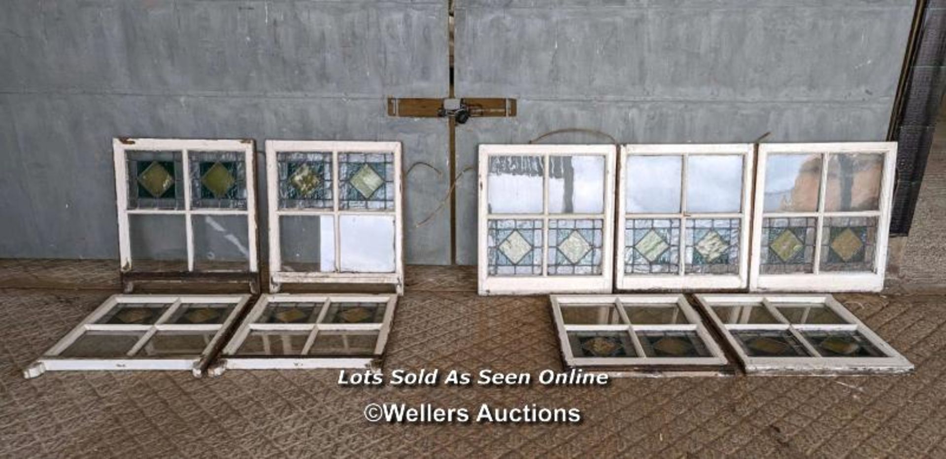 9 stained glass panels in pine frames from a sash window. Some breaks in the glass. Approx size each