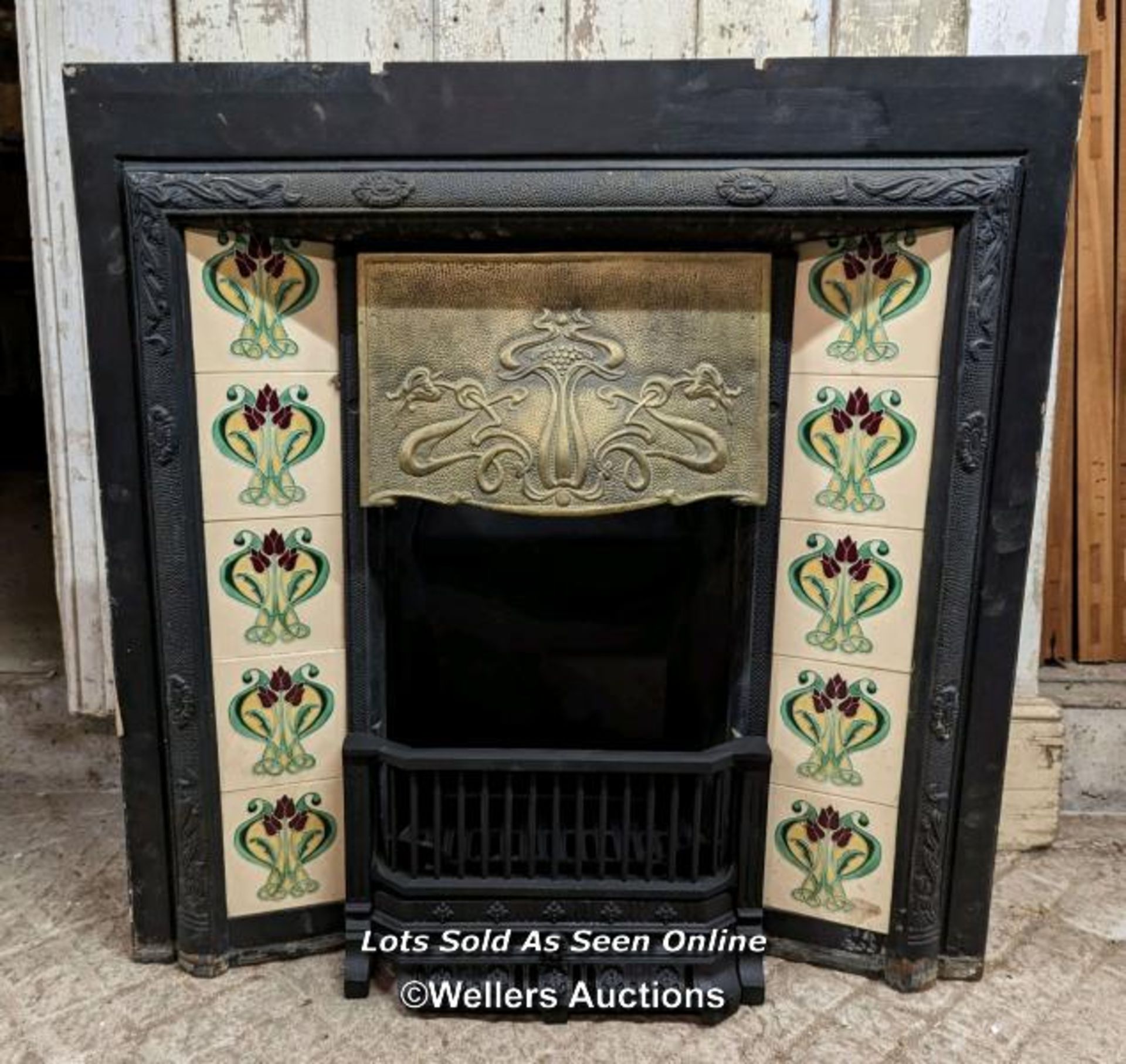 A reclaimed cast iron tiled fireplace. Art Nouveau design. This is a good quality reproduction fire.