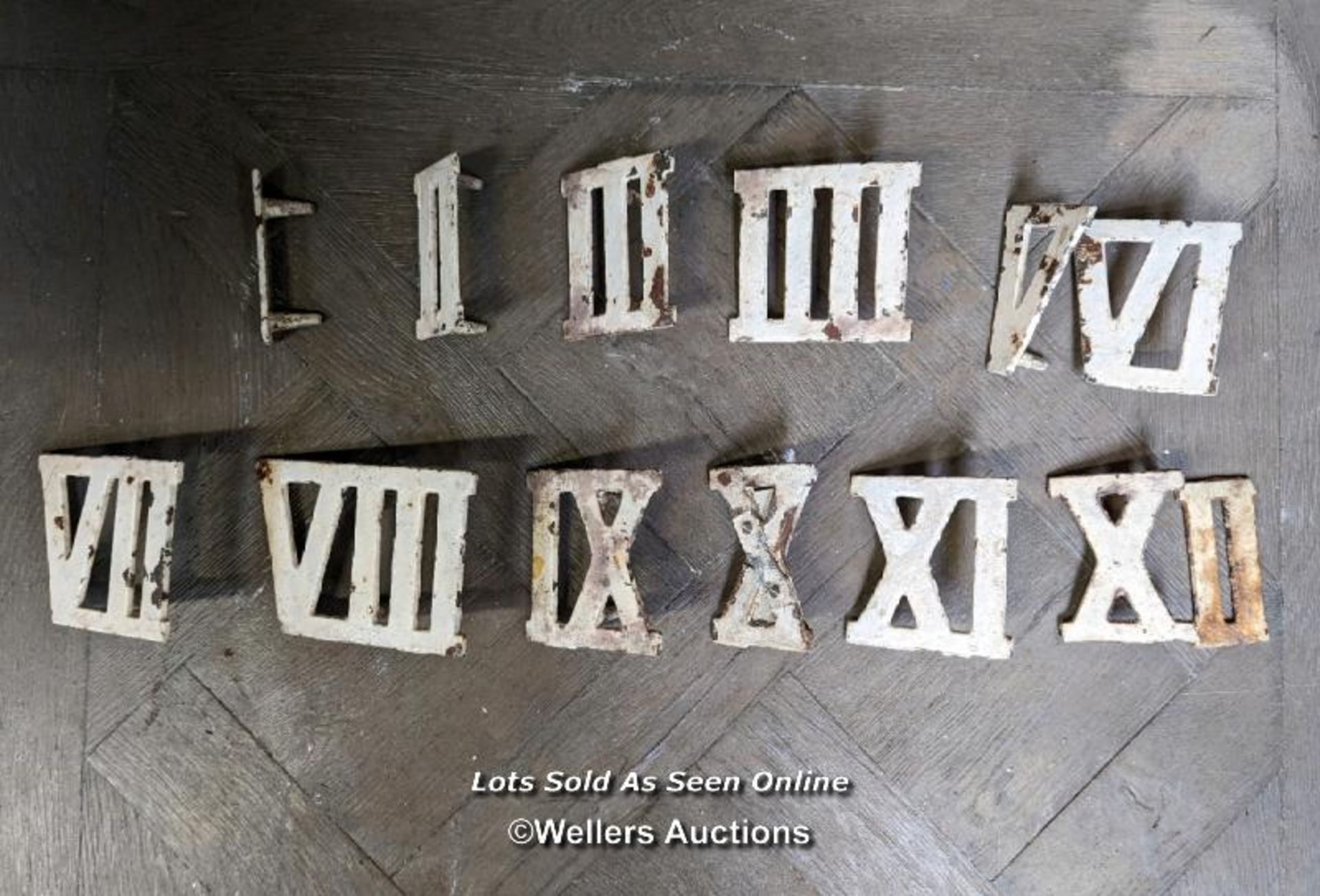 Set of cast iron roman numerals for use as a clock golf set. Each 9cm tall with spike to press