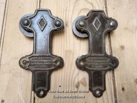 Rare cast iron pair of sliding door rollers stamped with makers mark, cast iron wheels. 23cm x 11cm
