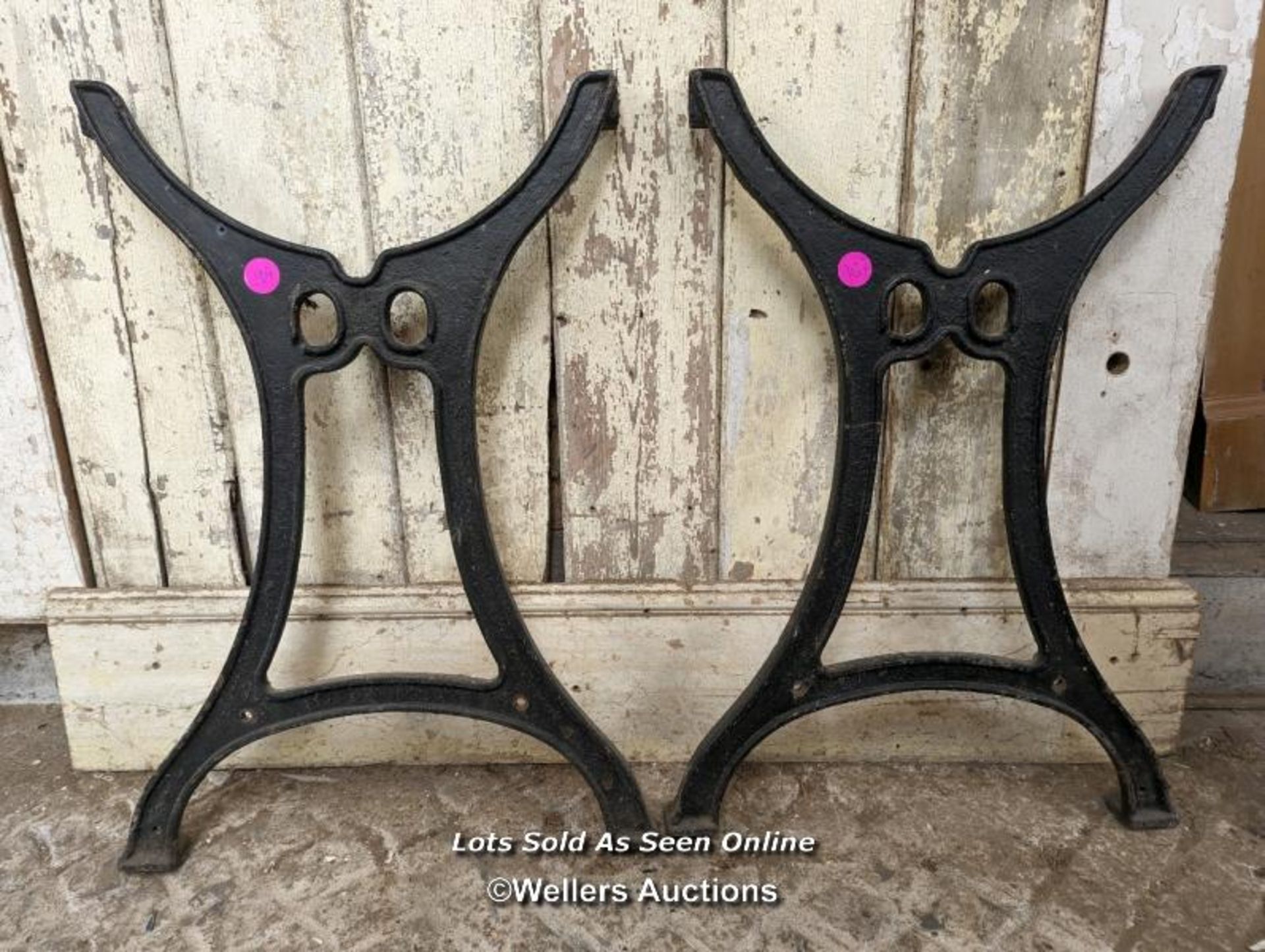 Pair of metal table ends. Cast iron, 74cm H x approx 50cm W