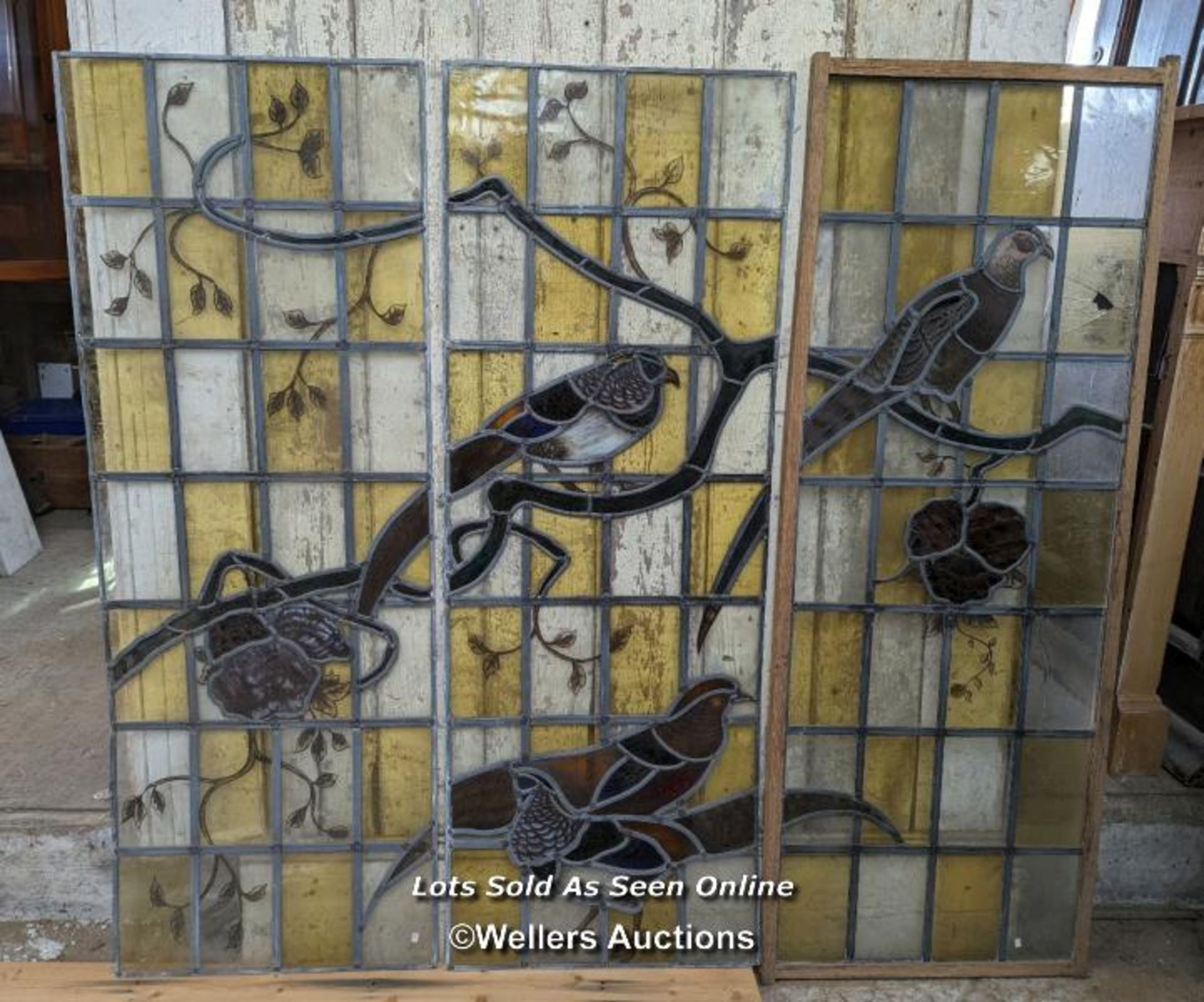 Series of three stained glass panels with handpainted birds of the field. Small areas of damage.