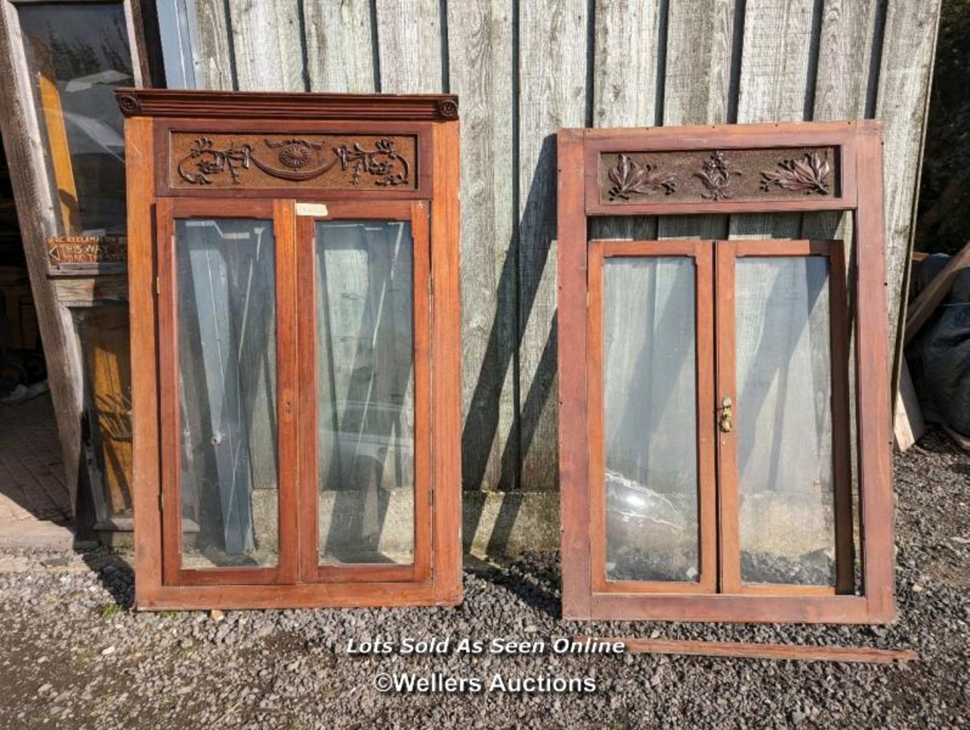 Two pairs of mahogany glazed doors each in a frame with handcarved header. From 1890 from HMS