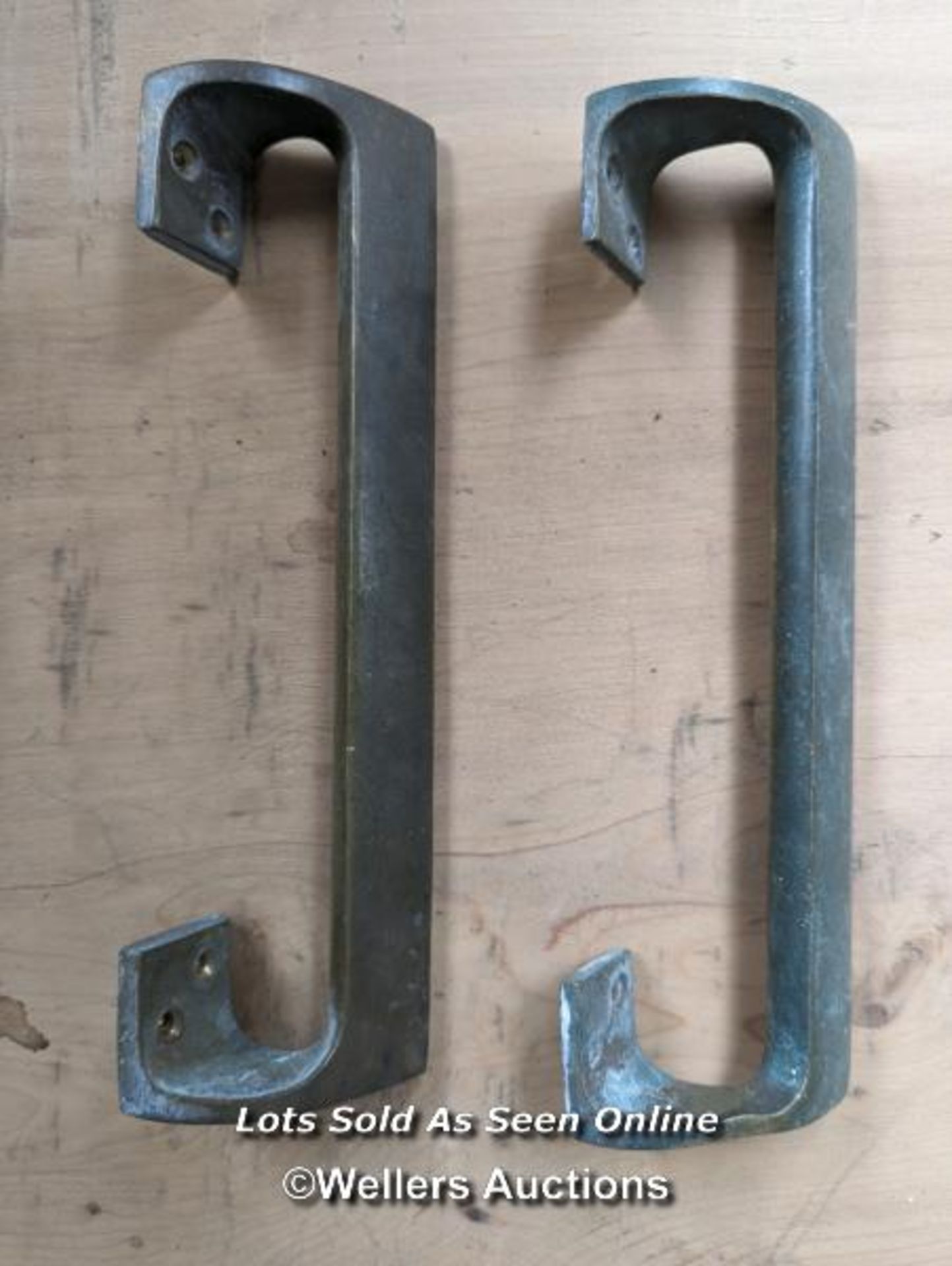 A pair of Brass art deco door pulls. 23cm tall.