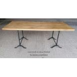 A table with a pair of Victorian cast iron trestles and a new oak top. 203cm L x 82cm W x 76cm T.