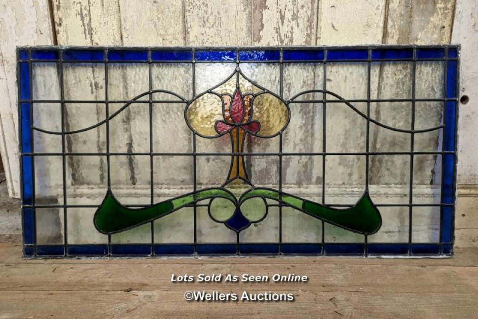 A large Art Nouveau stained glass panel. 58cm x 117cm. C1925