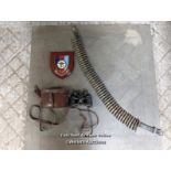 Mixed military lot. Pair of binoculars in a leather case. A belt of machine gun bullets 1974.