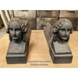 Pair of cast iron fire dogs or door stops with ladies' faces. 36cm L x 16cm H x 6.5cm W