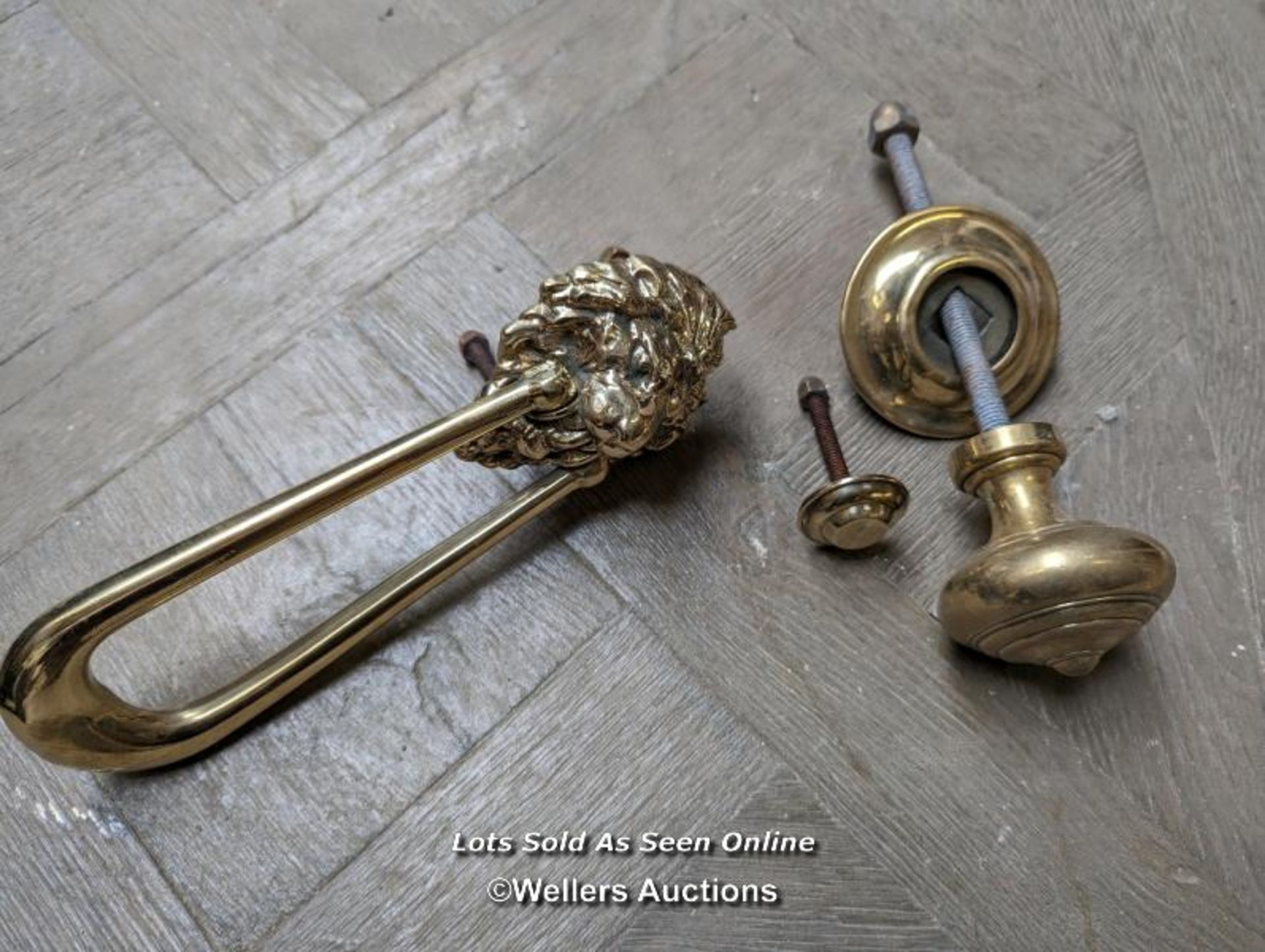 A brass lions head swag door knocker and brass doorpull. Both quality reproductions. Knocker is 23cm