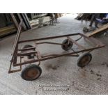 Vintage trolley on wheels with solid rubber tyres. All wheels turning, front axle. Angle iron