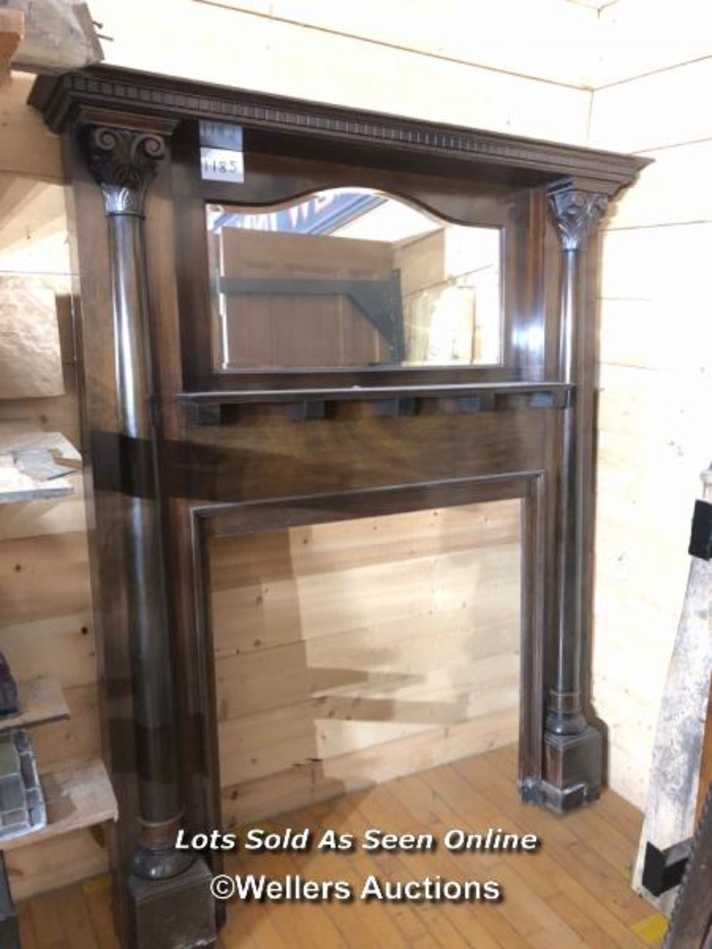 OAK FIREPLACE SURROUND, WITH BEVILED OVER MANTLE MIRROR AND FLANKED BY TWO DECORATIVE COLUMNS,