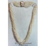 A multi row necklace of eleven rows of cultured freshwater rice pearls strung to clasp set with