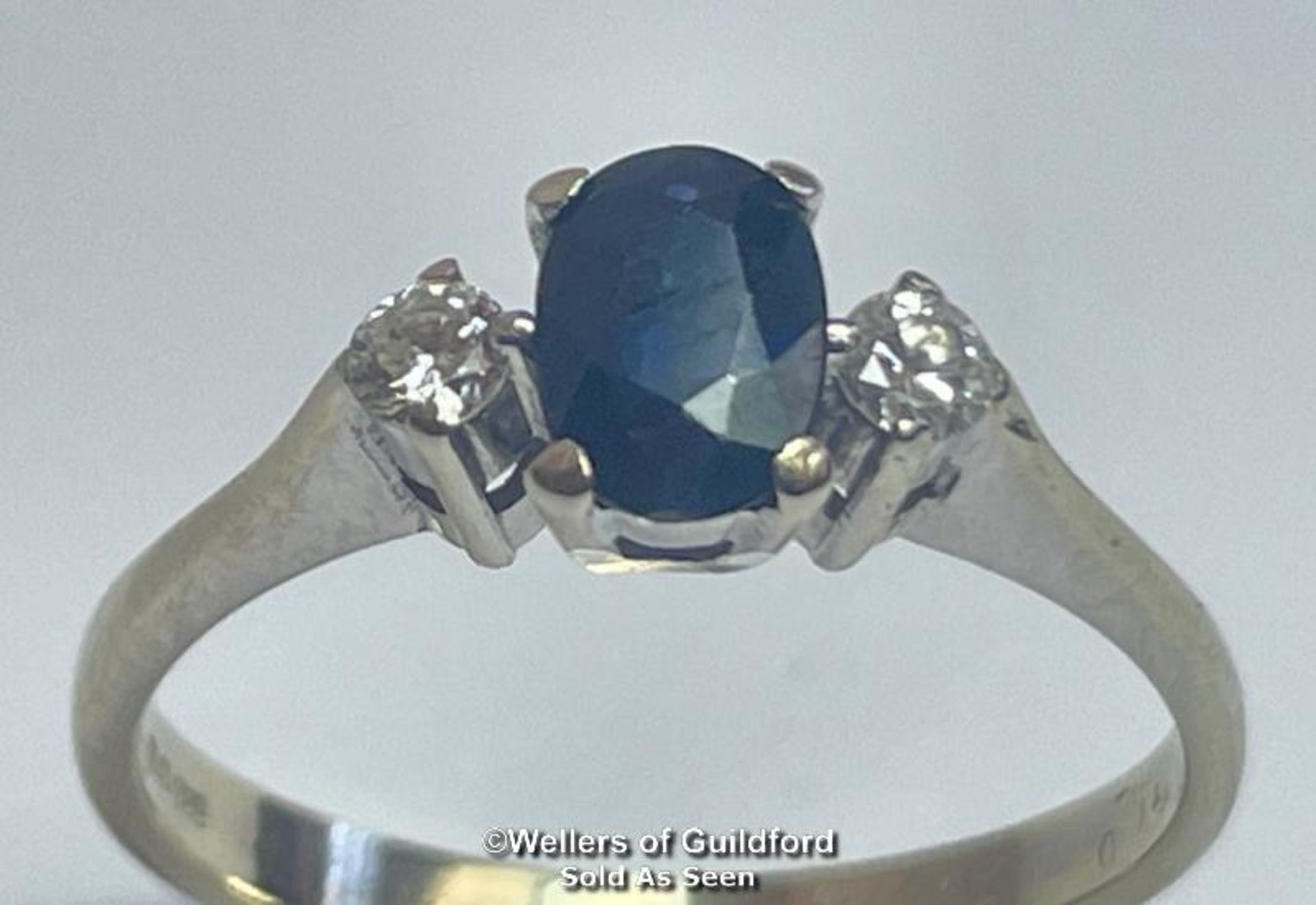 Oval sapphire and diamond three stone ring in 18ct gold. Estimated weight of saphire 0.67ct,