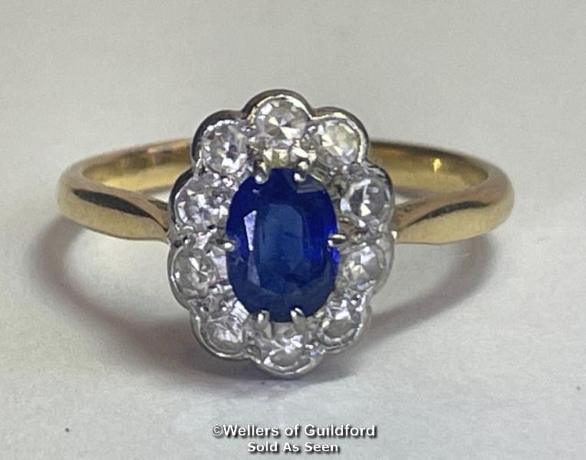 Sapphire and diamond cluster ring. An oval sapphire estimated weight 0.55ct surrounded by ten single - Image 2 of 5