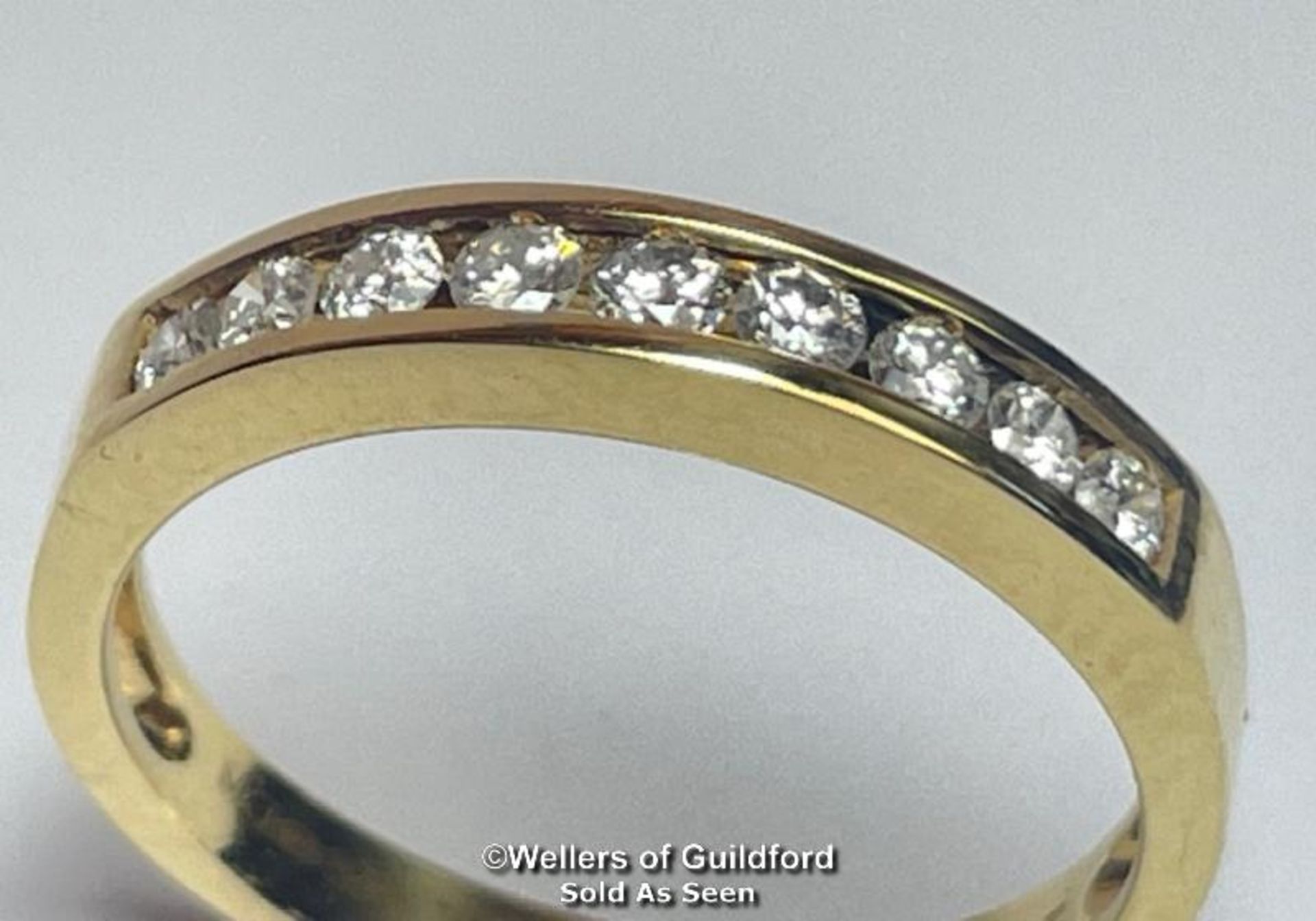 Diamond channel set eternity half band ring in hallmarked 18ct gold. Estimated diamond weight 0.