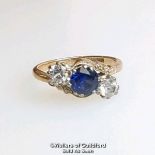 Synthetic sapphire and white sapphire three stone ring in a mount stamped 9ct gold. Ring size L.