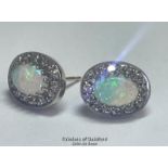 A pair of oval opal and diamond cluster earings in hallmarked 9ct gold. Opals measure approx 7mm x