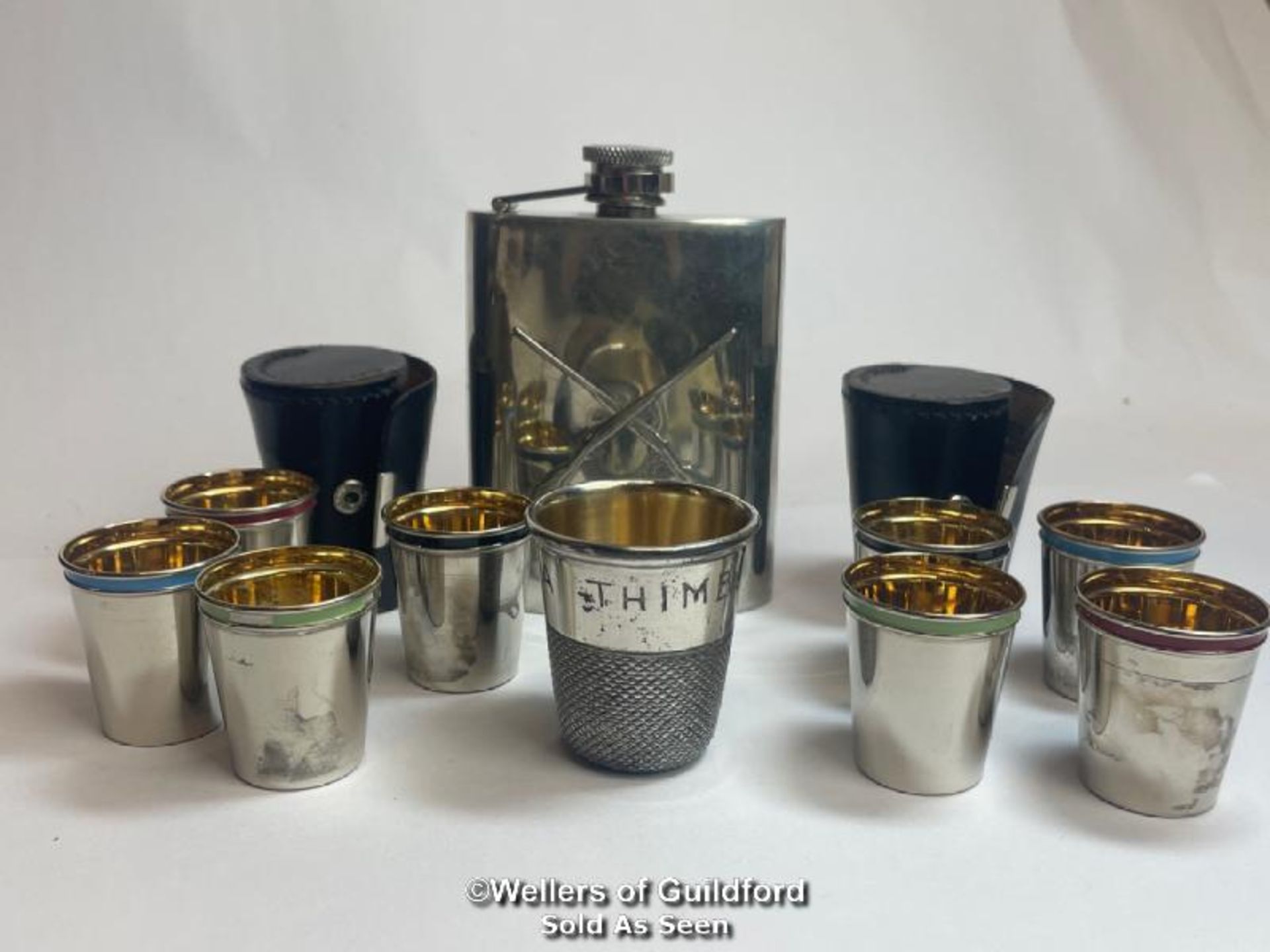 A pewter hip flask decorated with rifles by J.Purdy & Sons, novelty metal "thimble" shot glass and