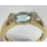 Oval blue topaz (untested) ring in yellow metal stamped 585, with diamond accents. Ring size K1/2,