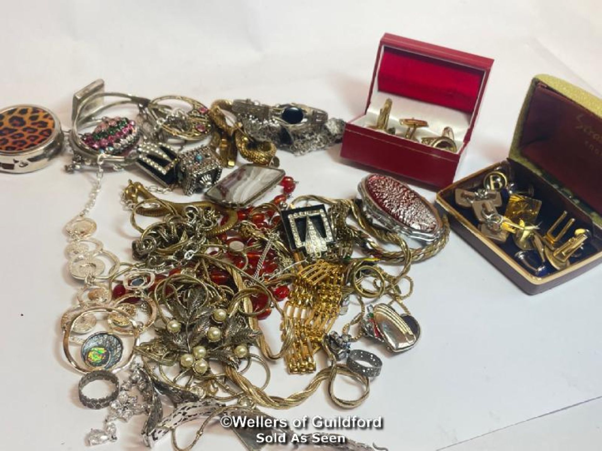 Assorted costume jewellery including brooches, necklaces, bangles and cufflinks