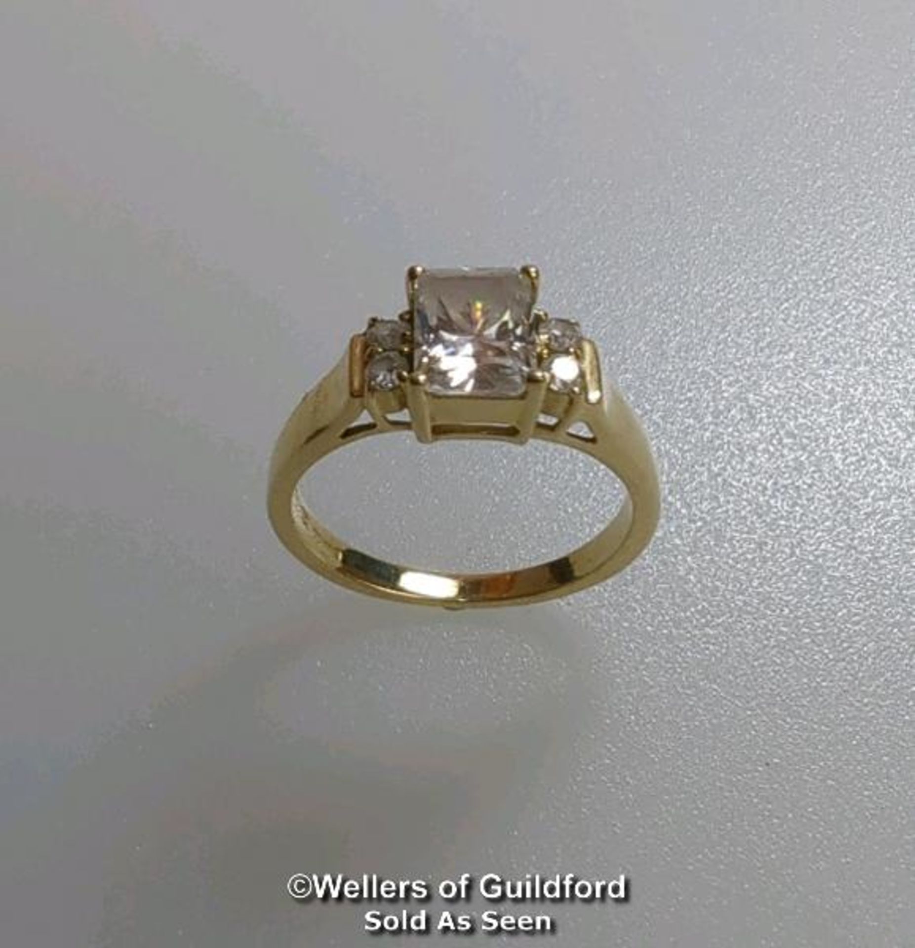 A cubic zirconia dress ring in hallmarked 14ct gold. The emerald cut centre stone measures 7mm x 5. - Image 7 of 8
