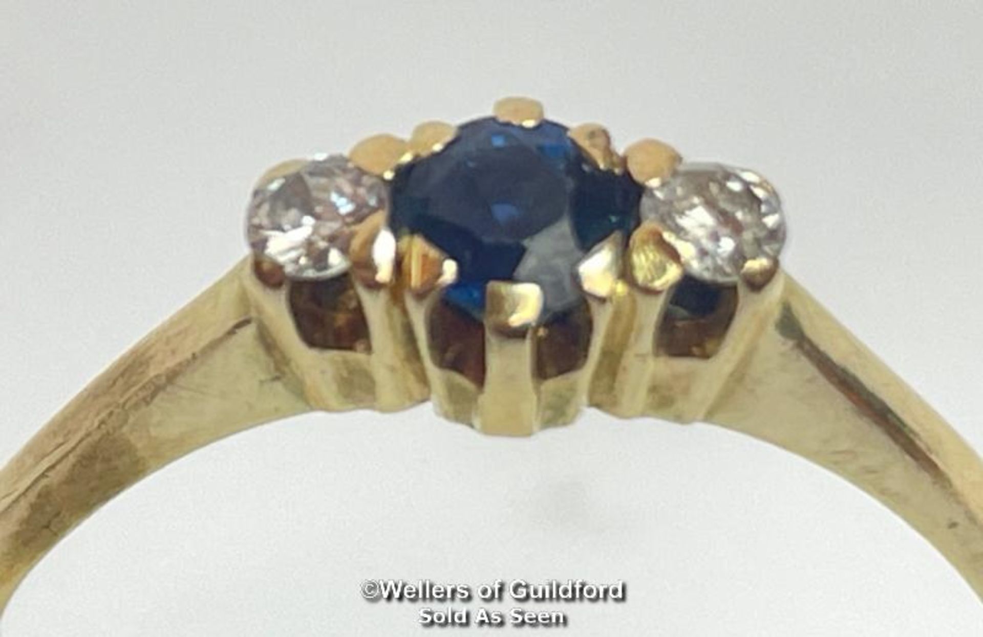 Sapphire and diamond three stone ring in unmarked yellow metal. Estimated weight of sapphire 0.40ct,