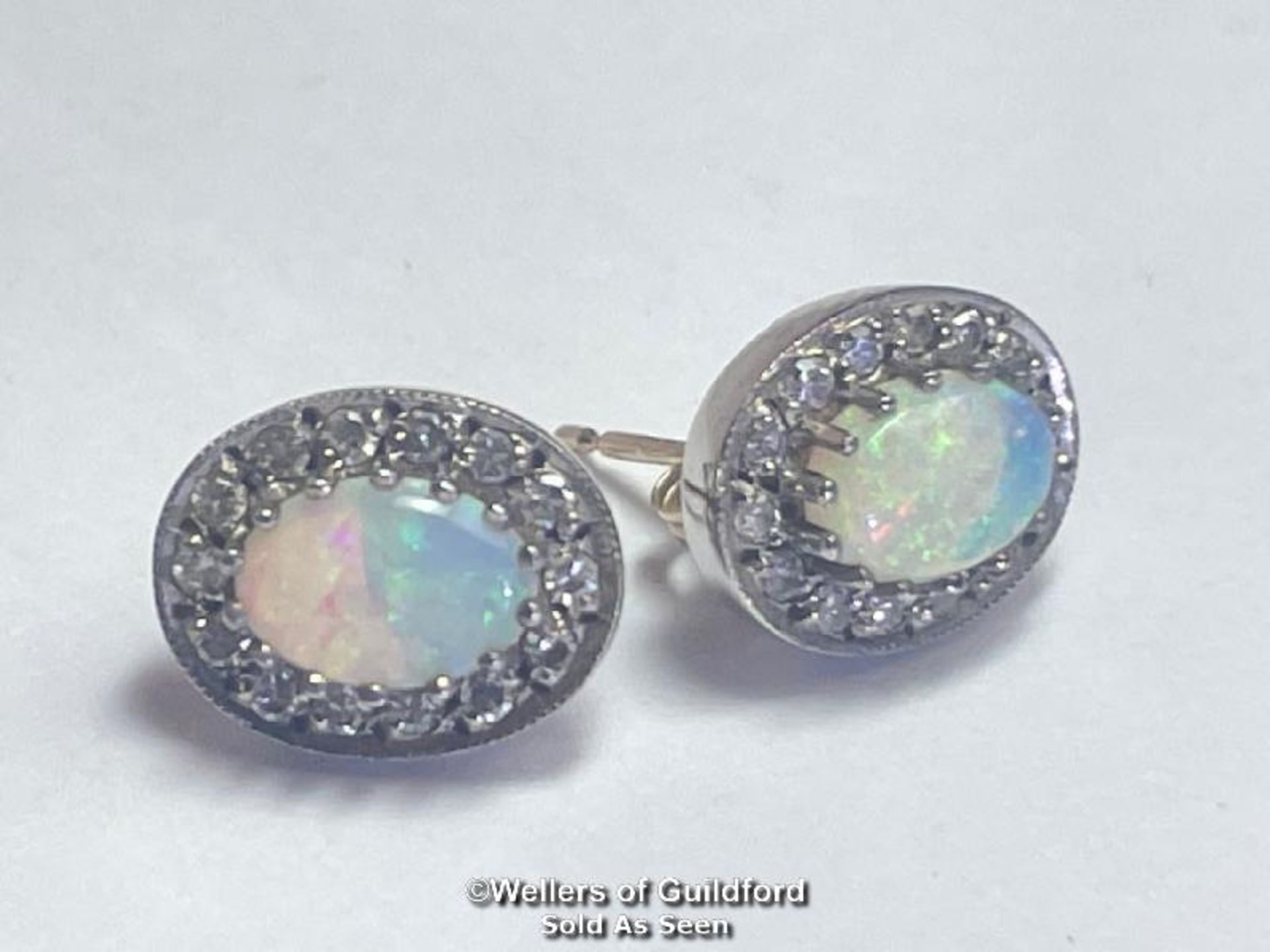 A pair of oval opal and diamond cluster earings in hallmarked 9ct gold. Opals measure approx 7mm x - Image 2 of 4