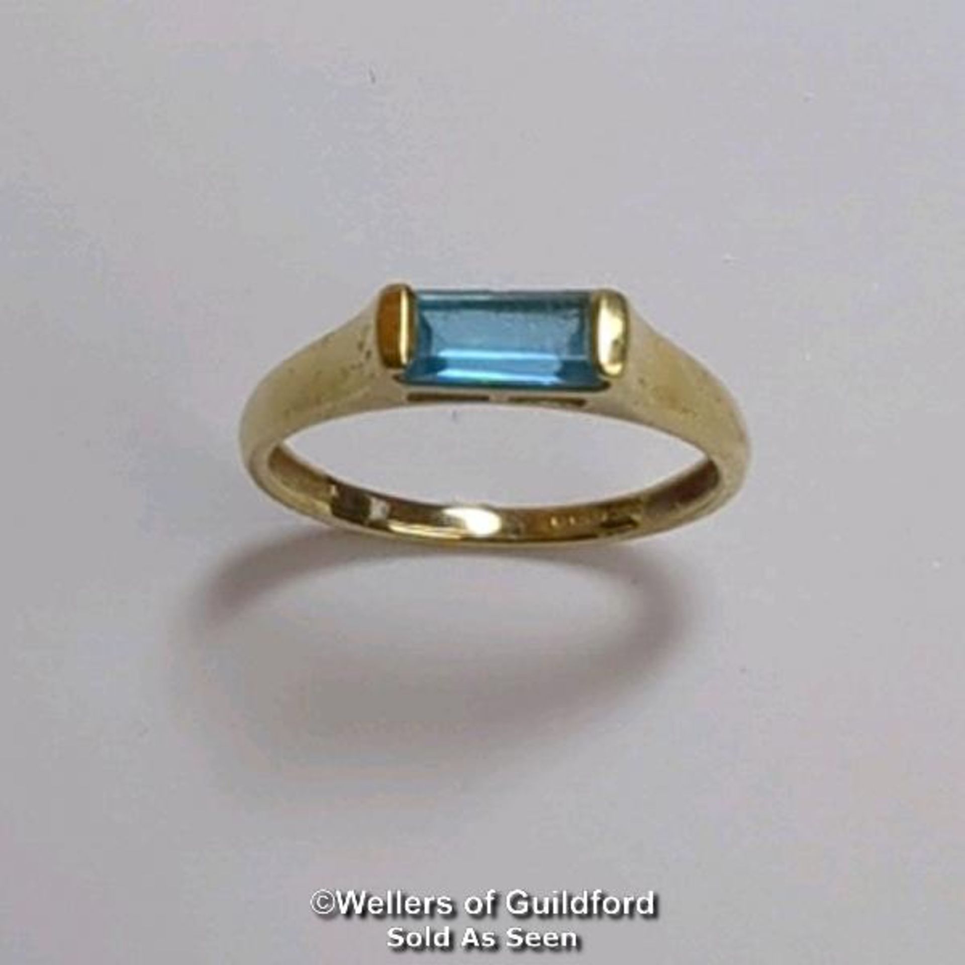Blue topaz (untested) single stone ring in hallmarked 9ct gold, by QVC. The baguette cut stone