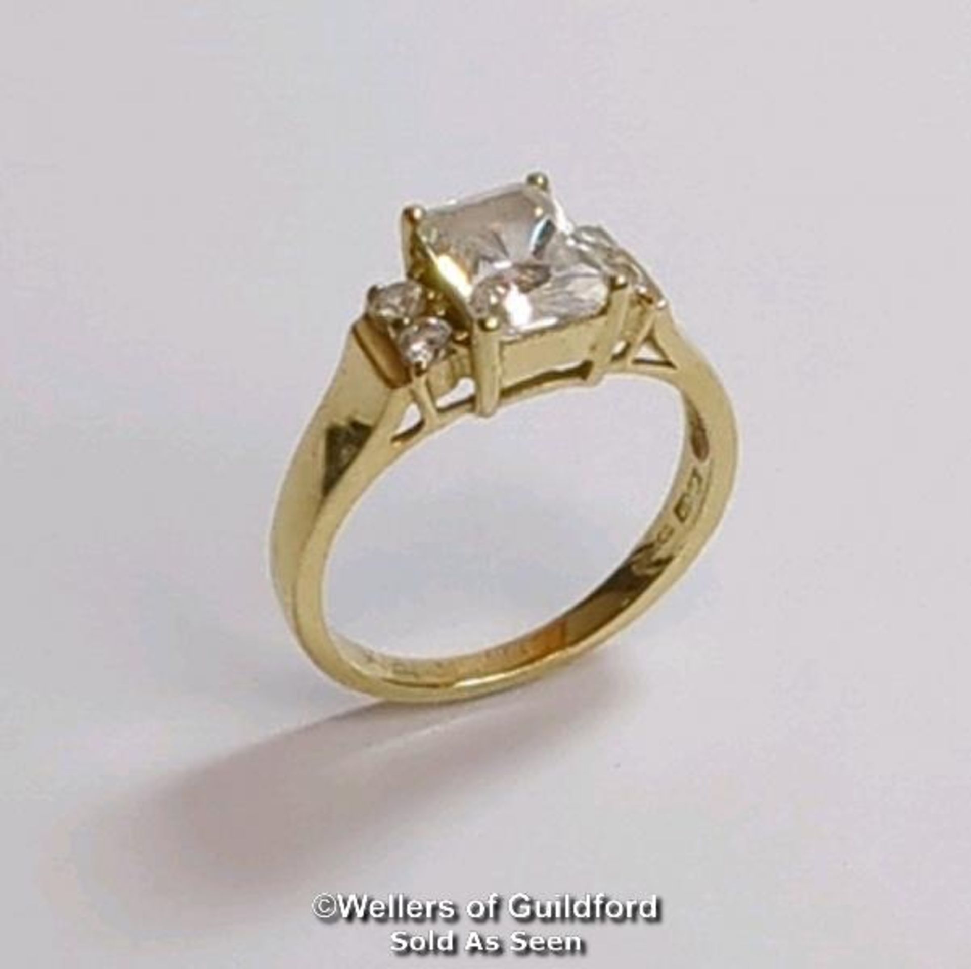 A cubic zirconia dress ring in hallmarked 14ct gold. The emerald cut centre stone measures 7mm x 5. - Image 2 of 8