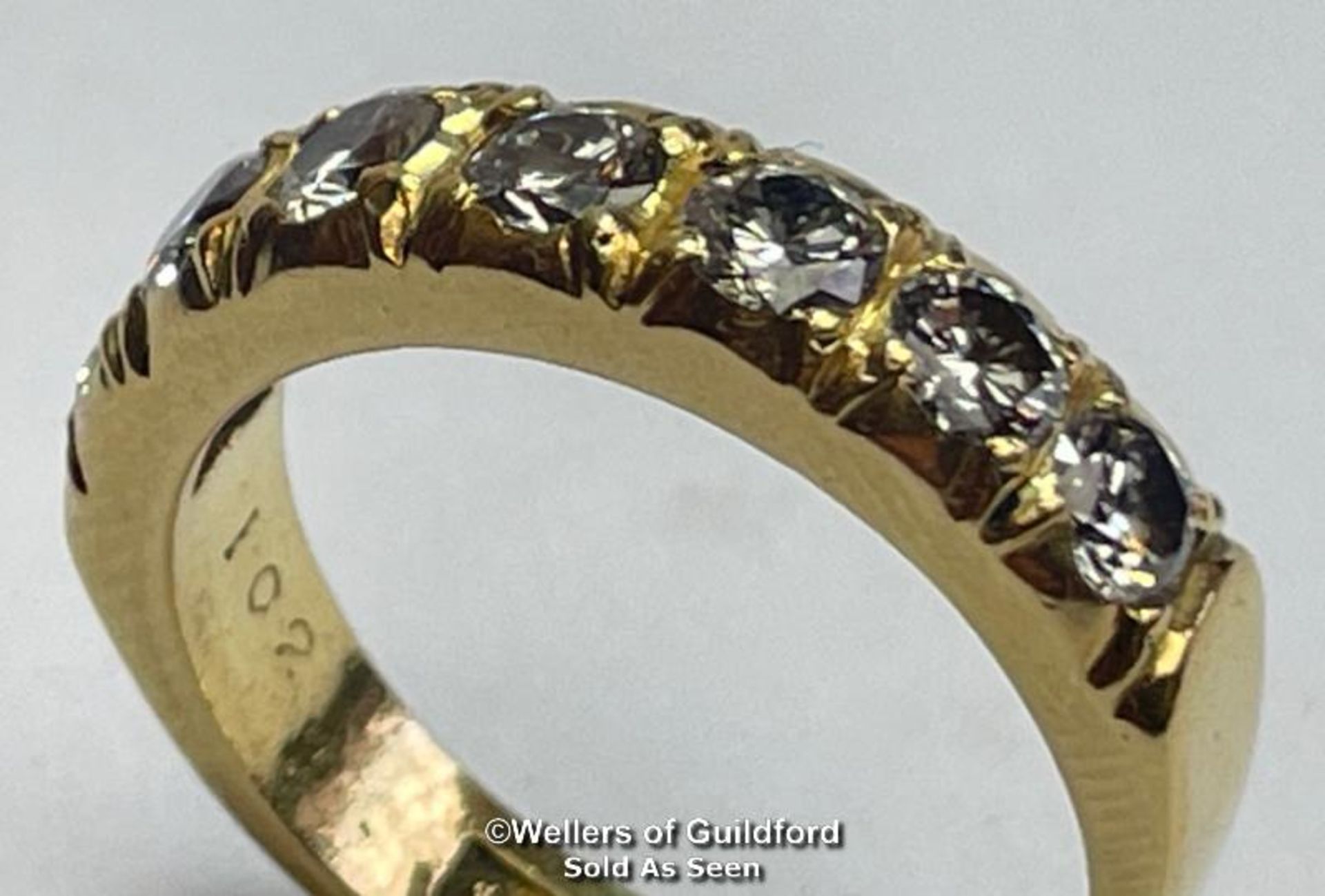 Diamond eternity half band ring in 18ct gold. Seven round cut brilliant diamonds estimated total