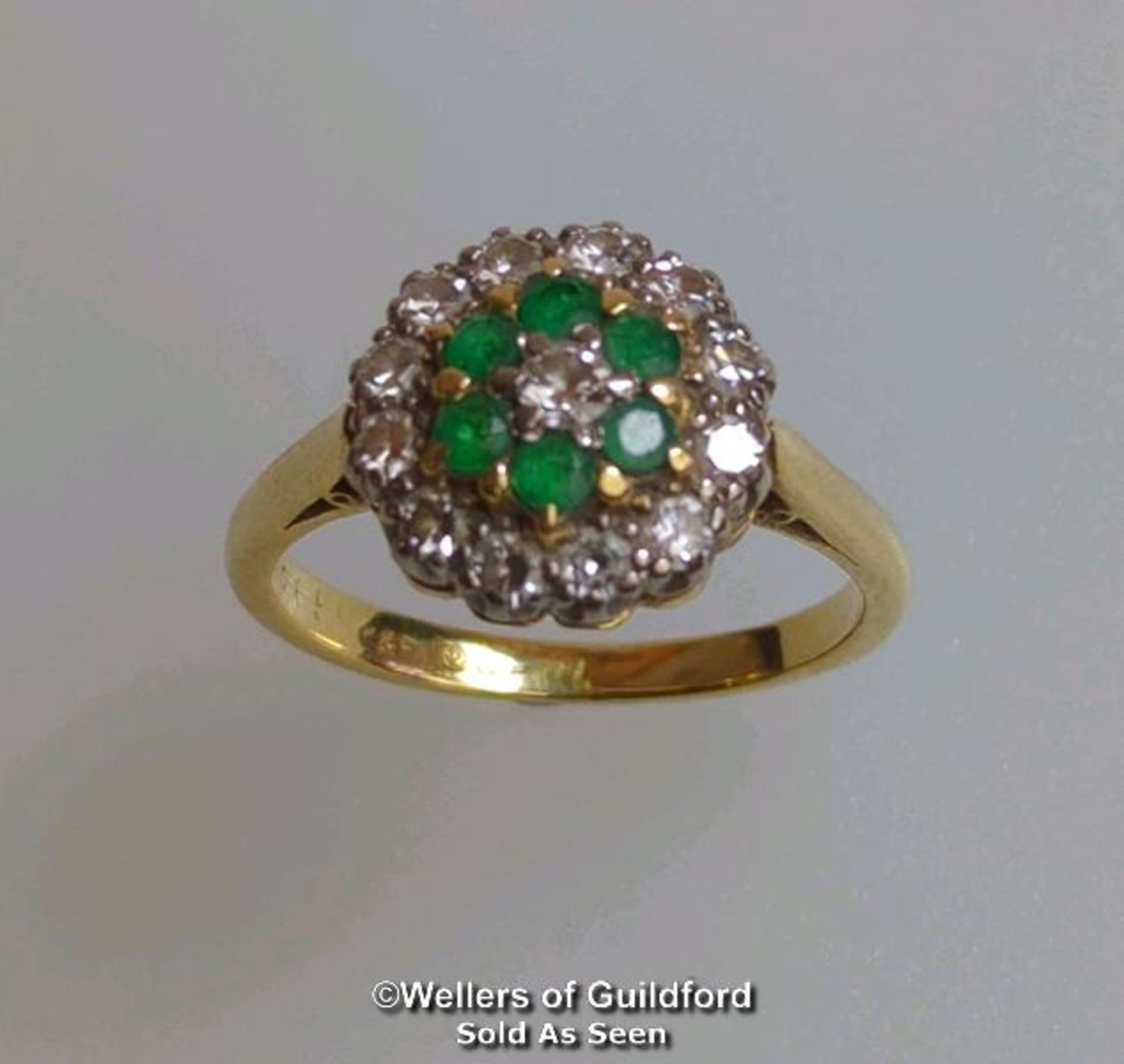 Emerald and diamond round cluster ring in hallmarked 18ct gold. Central brilliant cut diamond