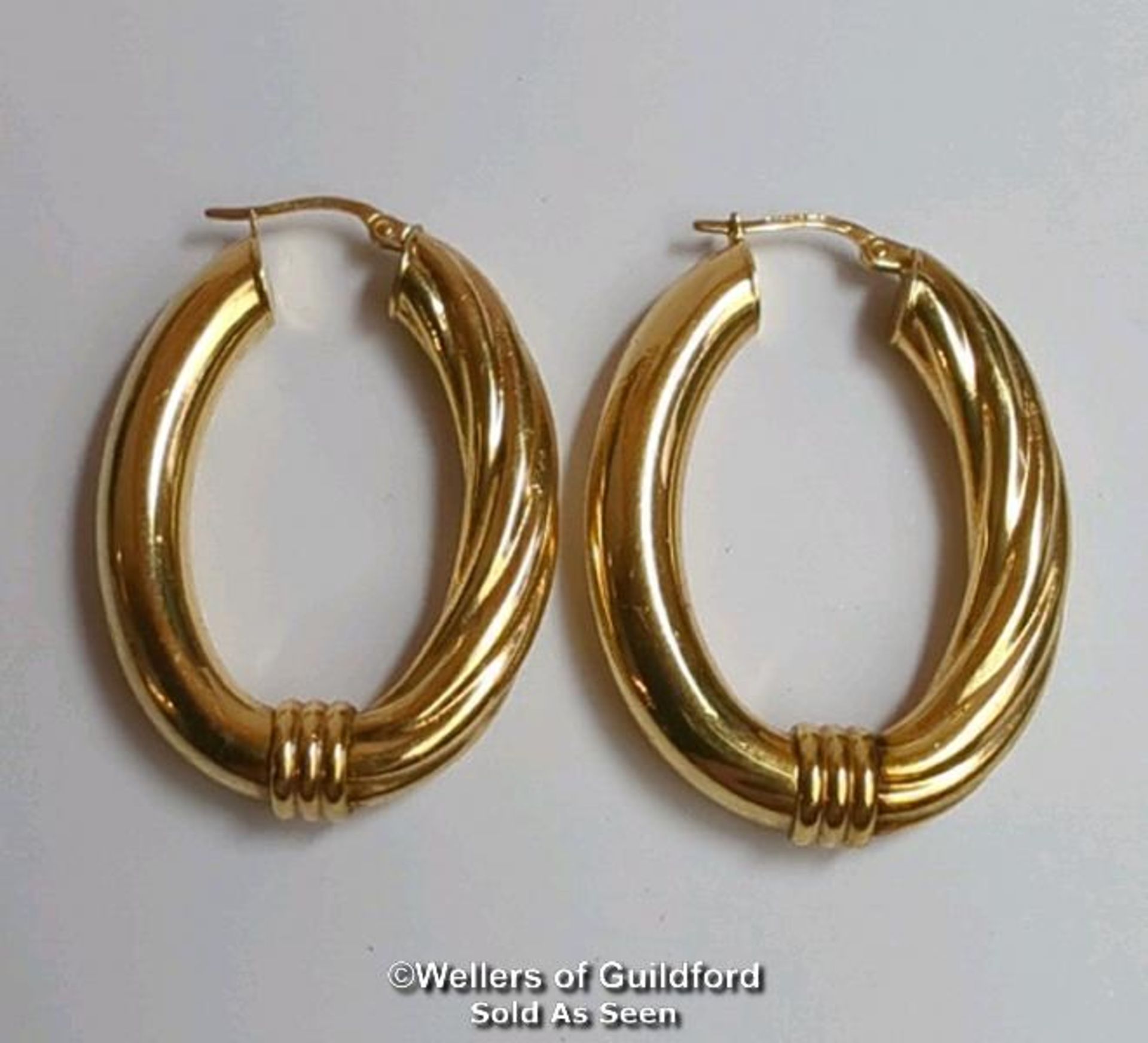 A pair of oval hoop earrings in hallmarked 9ct gold, length 4cm, gross weight 6.83g