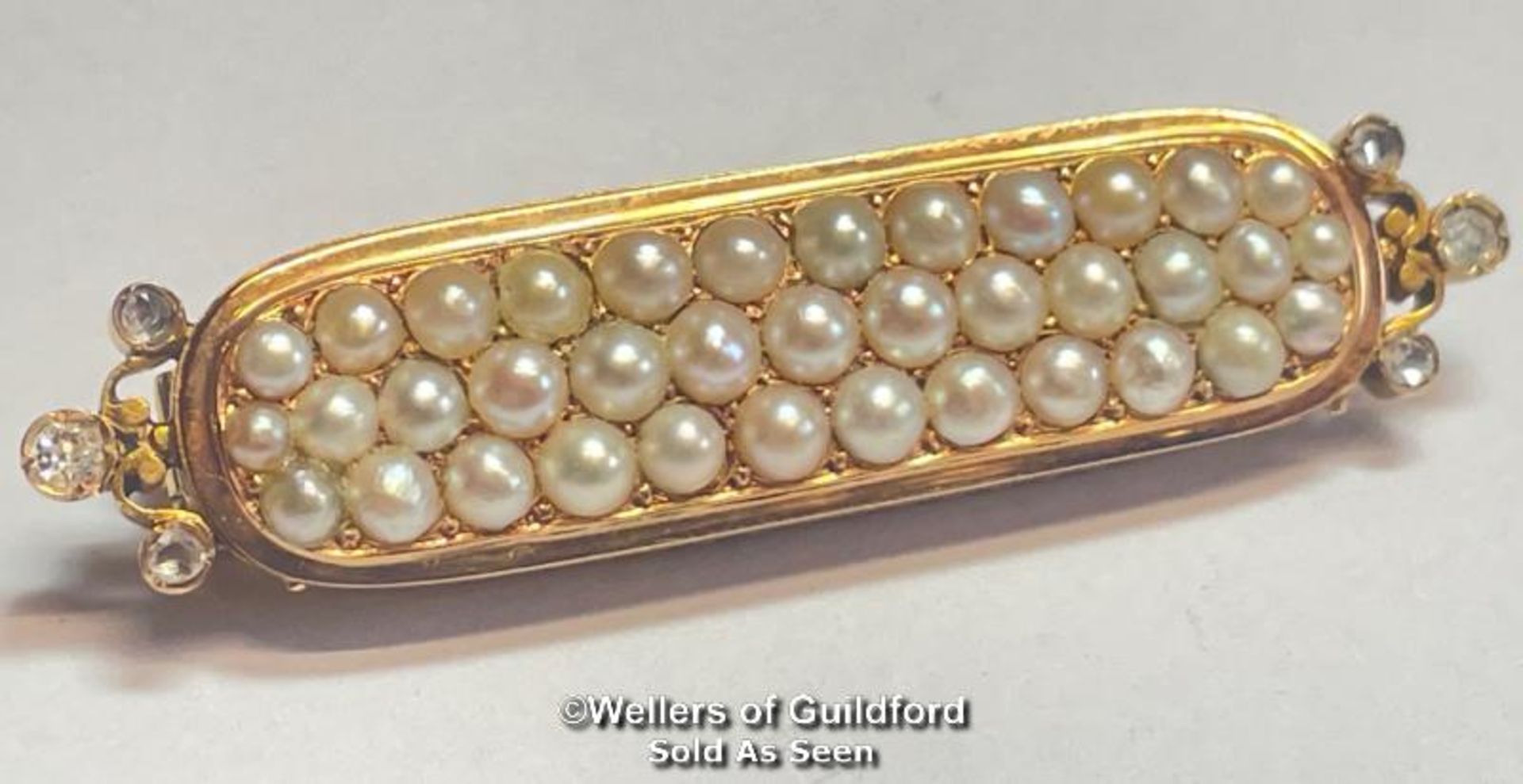 Stock pin in yellow metal with three rows of split pearls and rose cut diamond terminations, not