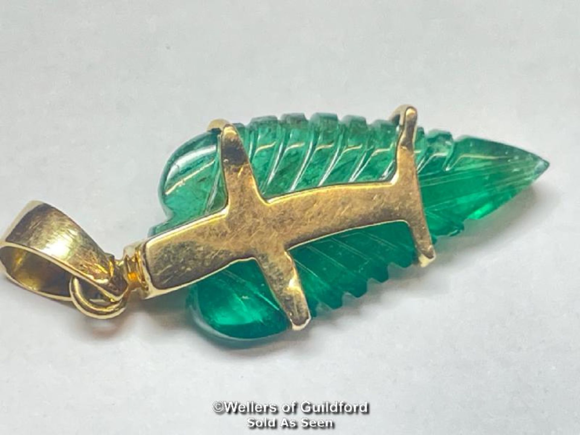 Leaf cut emerald pendant set with thirteen brilliant cut diamonds, estimated diamond weight 0. - Image 2 of 4
