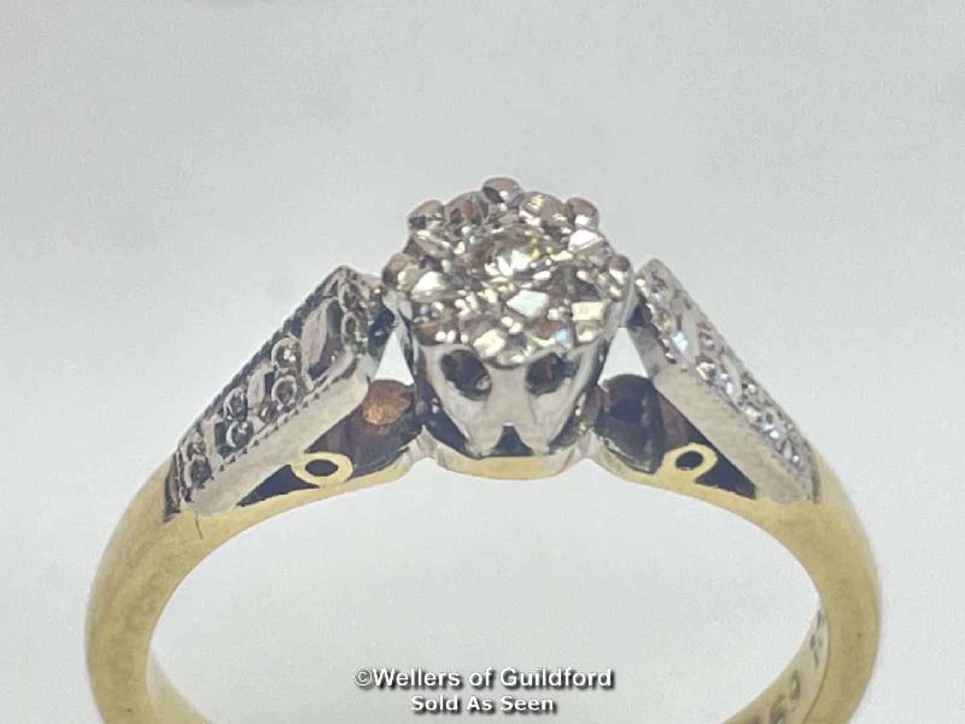 Illusion set diamond solitare ring in yellow and white metal stamped 18ct. Estimated diamond