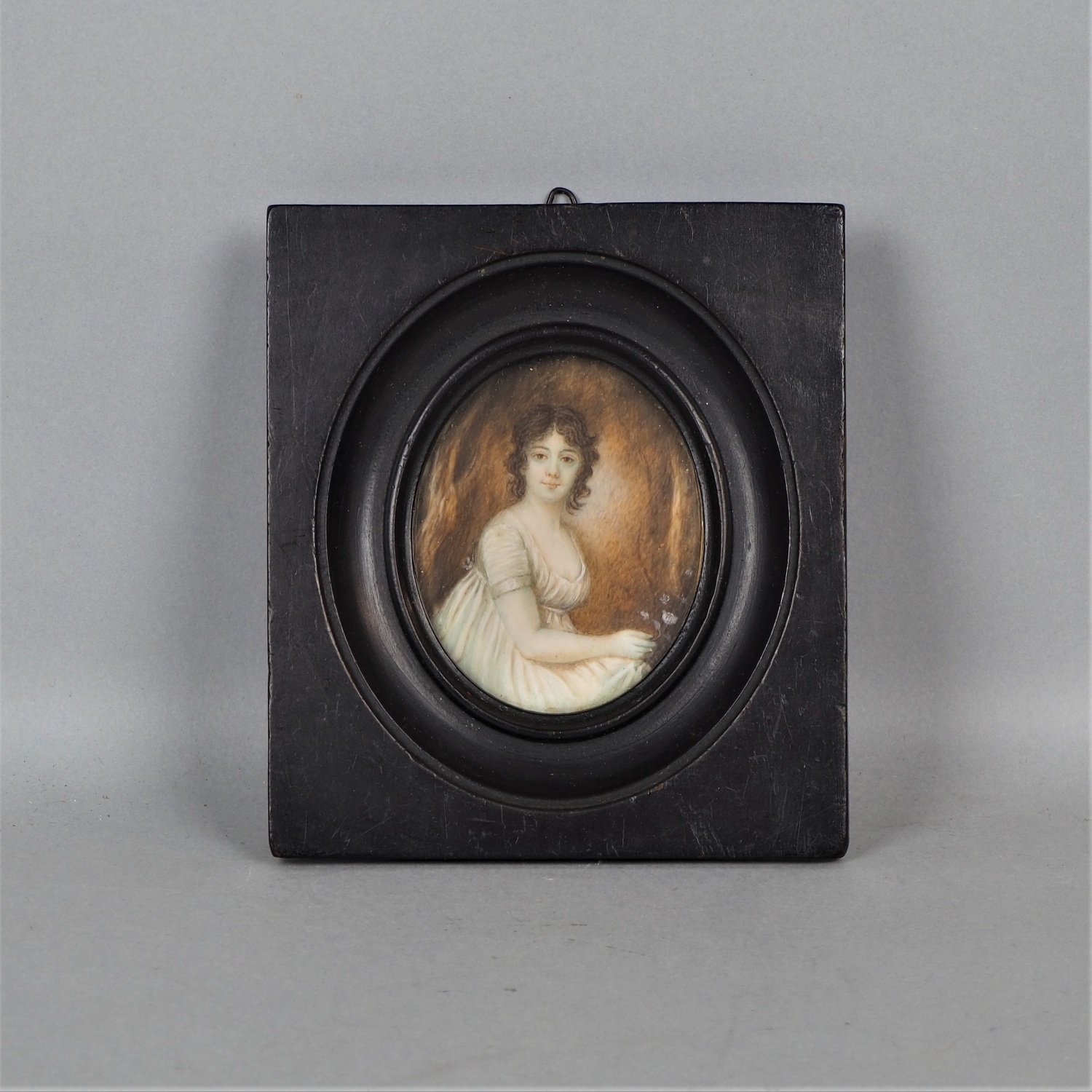 Oval miniature of a young woman with flower, 19th c.