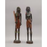 Paar Holzskulpturen (Afrika), 'Mann' und 'Frau', handgschn. Ebenholz, mit Attributen/Perlen