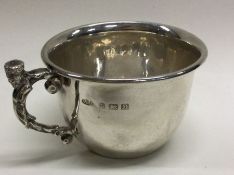 A fine silver christening mug with cast figural handle. Birmingham 1936. By AE Jones. Approx. 99