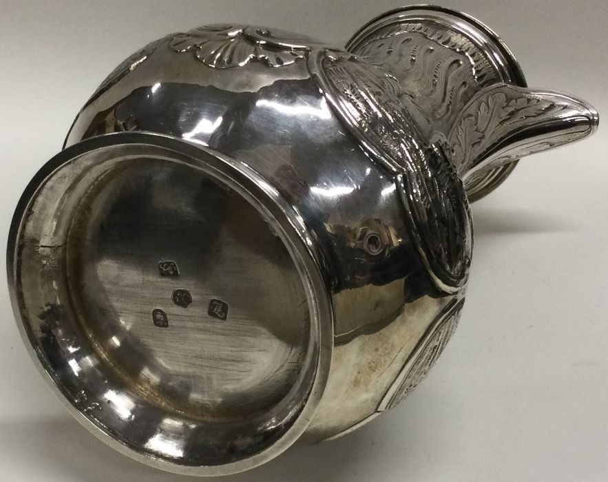 A heavy chased 18th Century Georgian silver jug of Chinoiserie design. London 1766. By Thomas and - Image 3 of 3