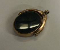 A rose gold mounted spinning fob set with bloodsto