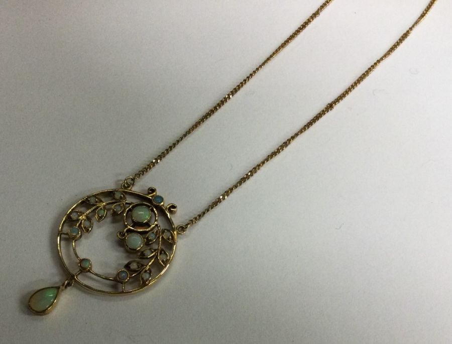 An attractive opal drop pendant of circular form o