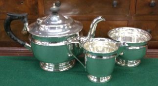 A heavy circular silver three piece tea set. Sheff