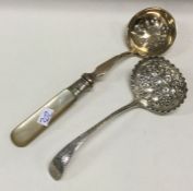 A chased silver sifter spoon together with one oth